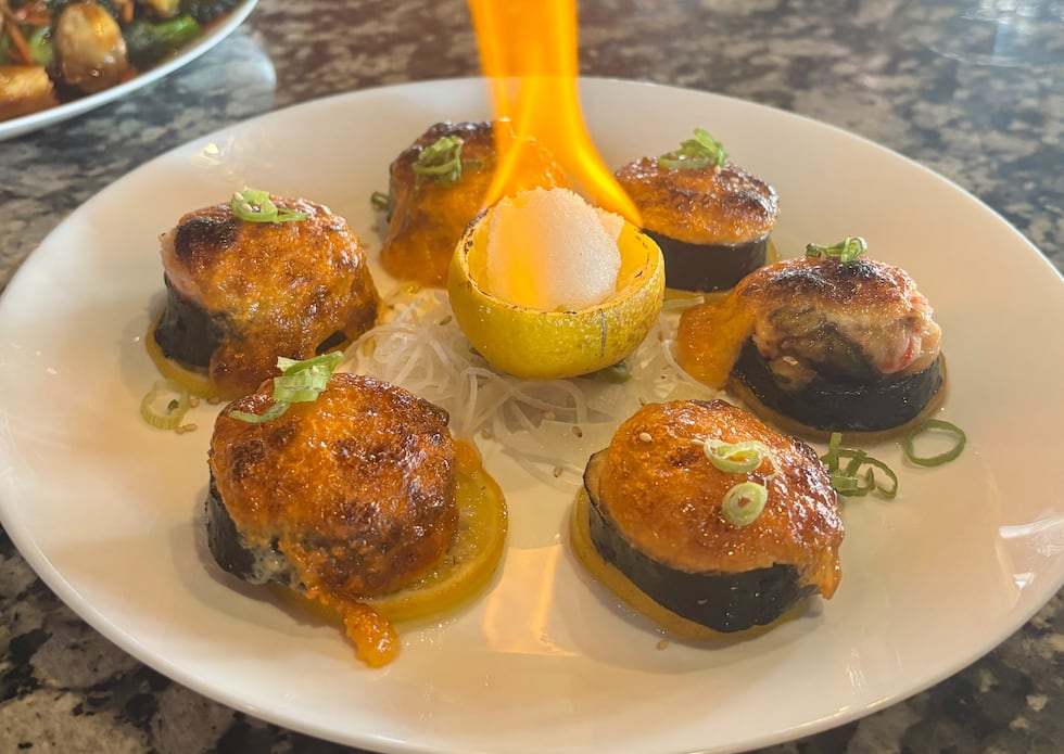 The salmon volcano roll is a sushi roll made with salmon, crab mix, avocado, Dynamite sauce...