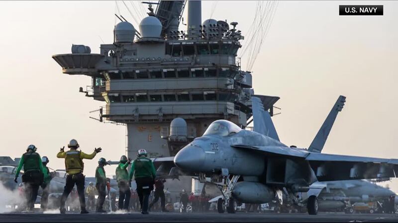 The U.S. Navy said a fighter jet slipped off the hangar deck of an aircraft carrier and into...