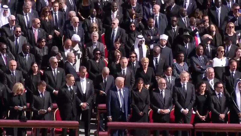 President Trump and former President Biden stand in different rows during Pope Francis'...