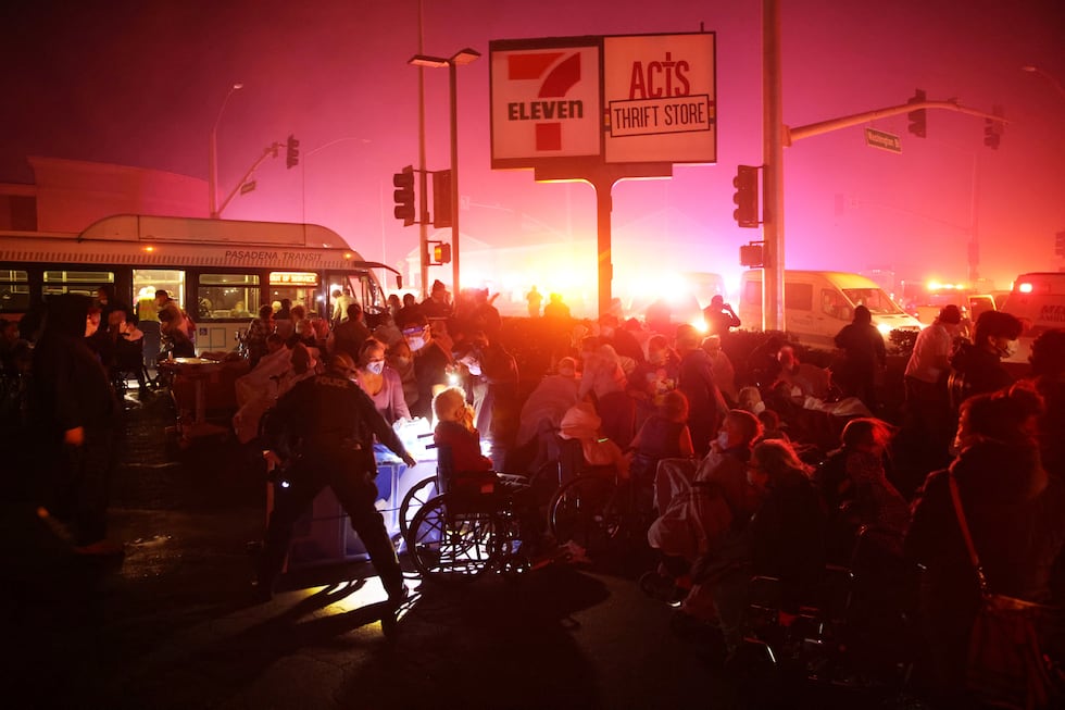 Residents of a senior center are evacuated as the Eaton Fire approaches Tuesday, Jan. 7, 2025,...
