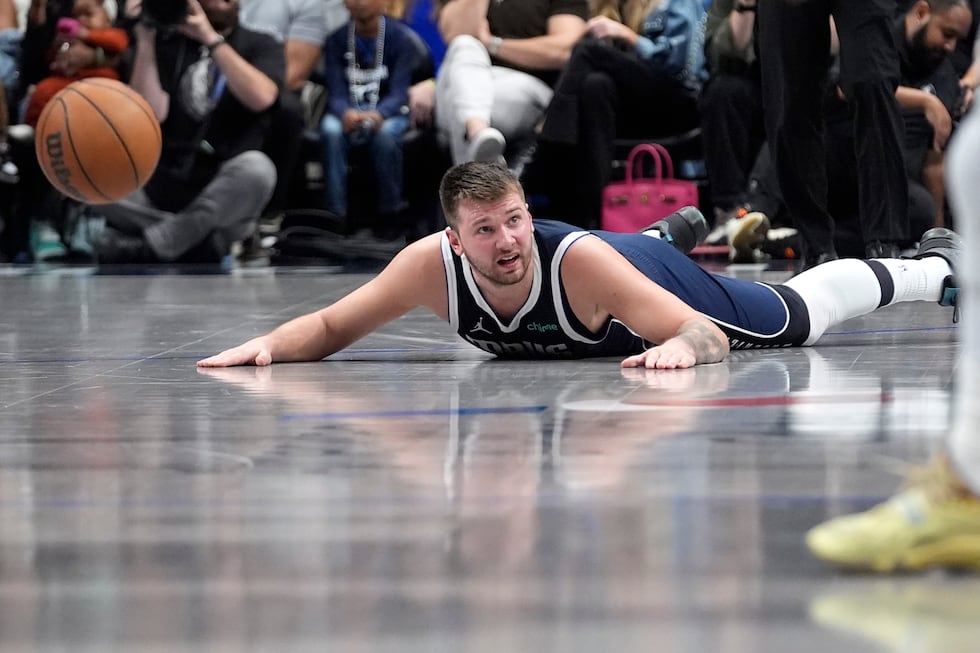 Dallas Mavericks guard Luka Doncic looks for the foul to be called after he fell during the...