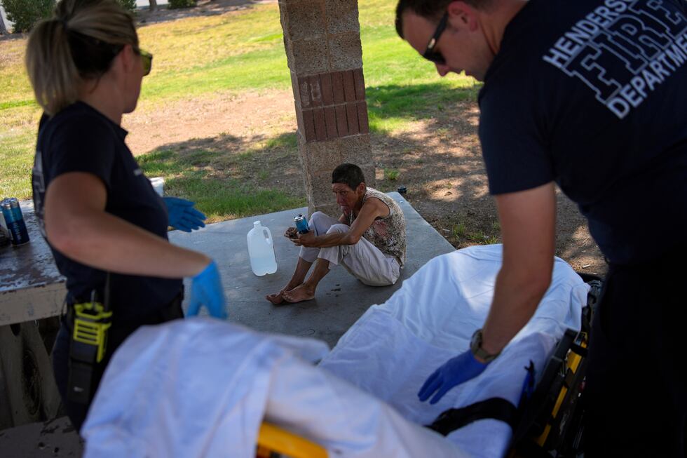 Members of the Henderson Fire Department prepare to take Deb Billet, 66, to the hospital for...