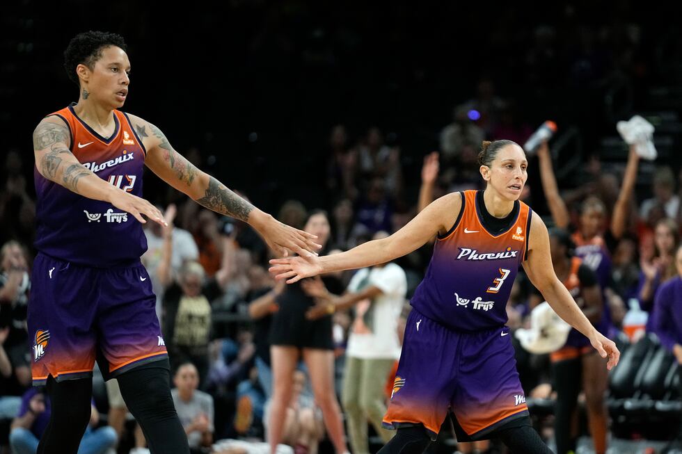 FILE - Phoenix Mercury center Brittney Griner, left, celebrates a score by guard Diana Taurasi...