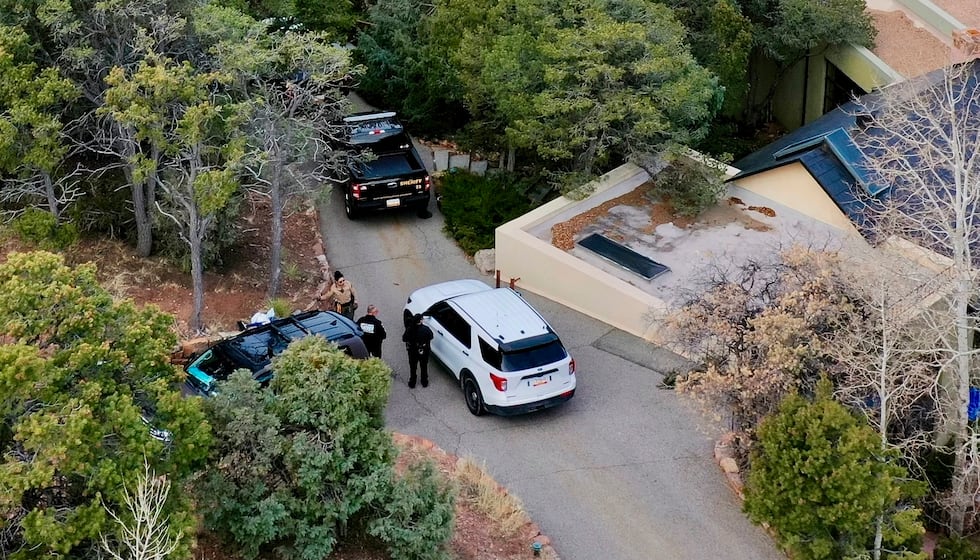 FILE - Law enforcement officials talk outside the home of actor Gene Hackman on Feb. 27, 2025...