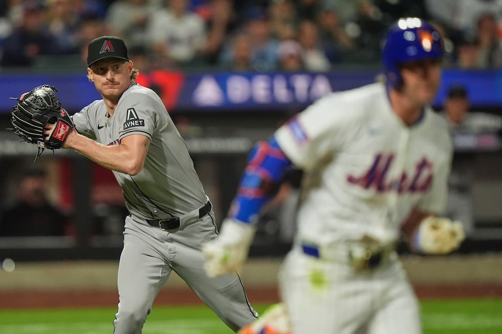 Arizona Diamondbacks pitcher Shelby Miller, left, throws to first base as New York Mets' Jeff...