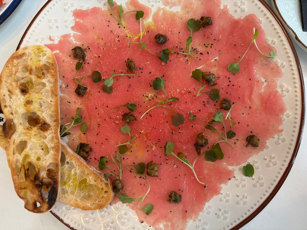 The Tuna Carpaccio is made with Ahi Tuna loin slivers pounded thin and topped with crispy...