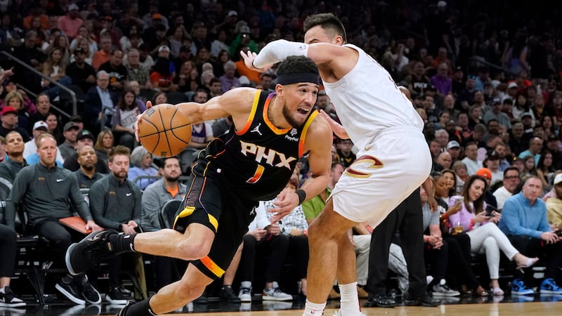 Phoenix Suns guard Devin Booker (1) drives to the basket against Cleveland Cavaliers guard Max...