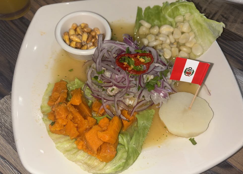 Ceviche made with lime juice, onions, celery, cilantro and aji amarillo sauce and served with...