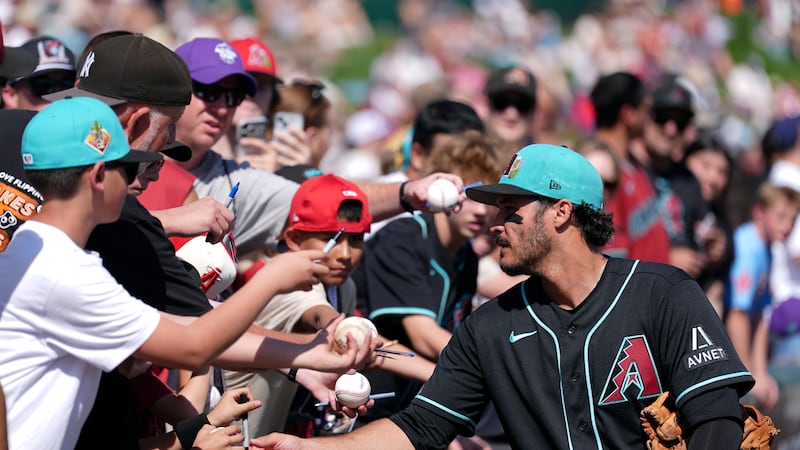 Arizona Diamondbacks' Nolan Arenado signs autographs prior to a spring training baseball game...