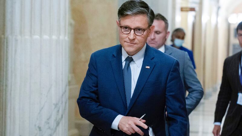 Speaker of the House Mike Johnson, R-La., walks to a meeting at the Capitol in Washington,...