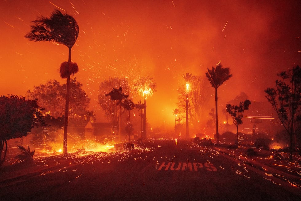 The Palisades Fire ravages a neighborhood amid high winds in the Pacific Palisades...