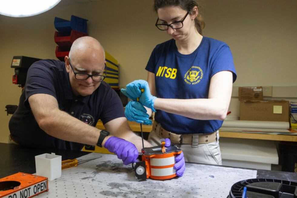 The National Transportation Safety Board (NTSB) investigator checks the cockpit audio recorder.