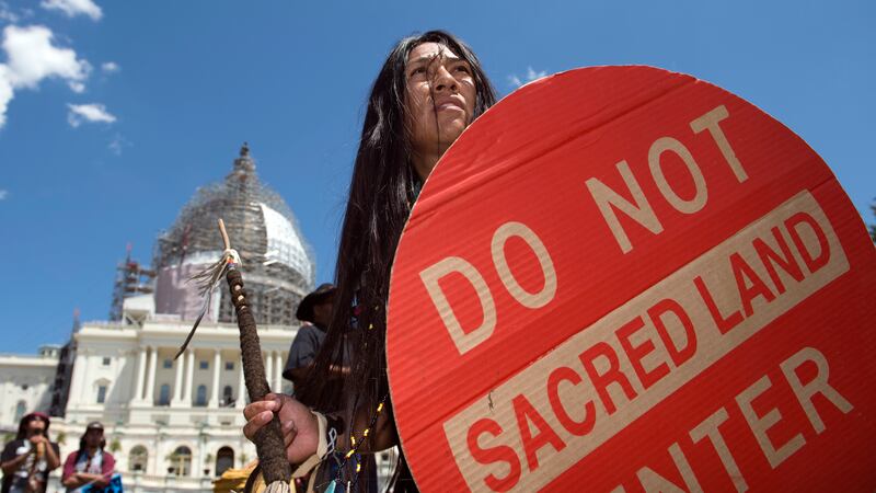 FILE - An Apache activist dancer performs in a rally to save Oak Flat, land near Superior,...