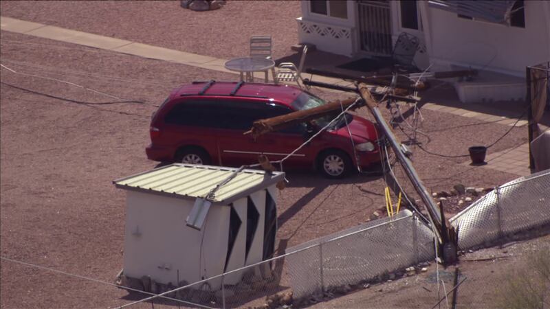 A minivan was damaged after a utility pole was toppled by a construction crane in Apache...