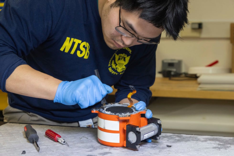 The National Transportation Safety Board (NTSB) investigator checks the cockpit audio recorder.