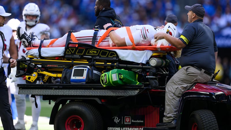 Arizona Cardinals tight end Travis Vokolek (81) gets carted off the field after getting...