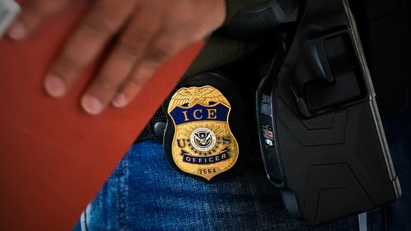 FILE - A deportation officer with Enforcement and Removal Operations in U.S. Immigration and...