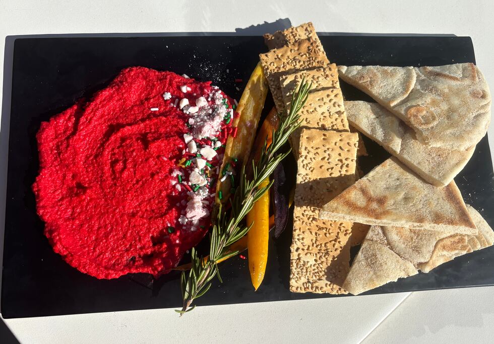 "HO HO Hummus" is a peppermint hummus served with naan flatbread, heirloom carrots and crackers.