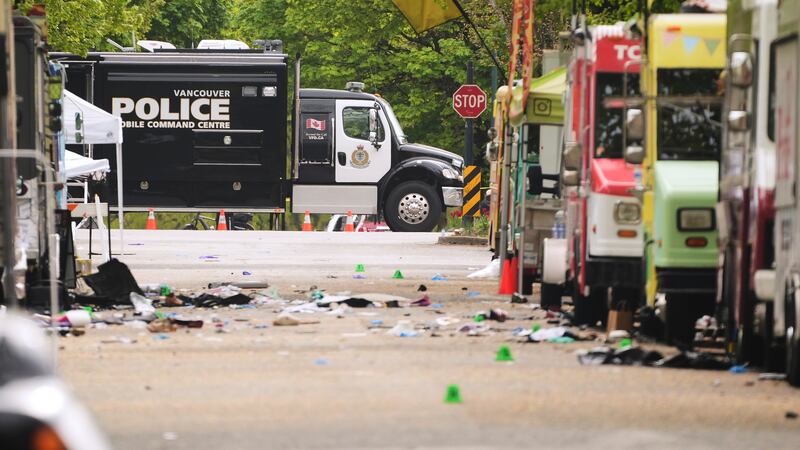 Evidence markers and Vancouver Police vehicles sit at a scene after a driver killed multiple...