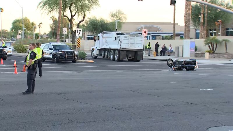 A motorcycle rider is hospitalized after colliding with a dump truck in Peoria.
