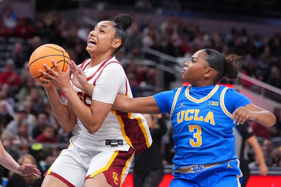 Southern California guard JuJu Watkins, left, grabs a rebound from UCLA guard Londynn Jones...