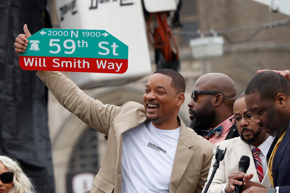 Will Smith holds up a street sign during a ceremony to name a street after him in West...