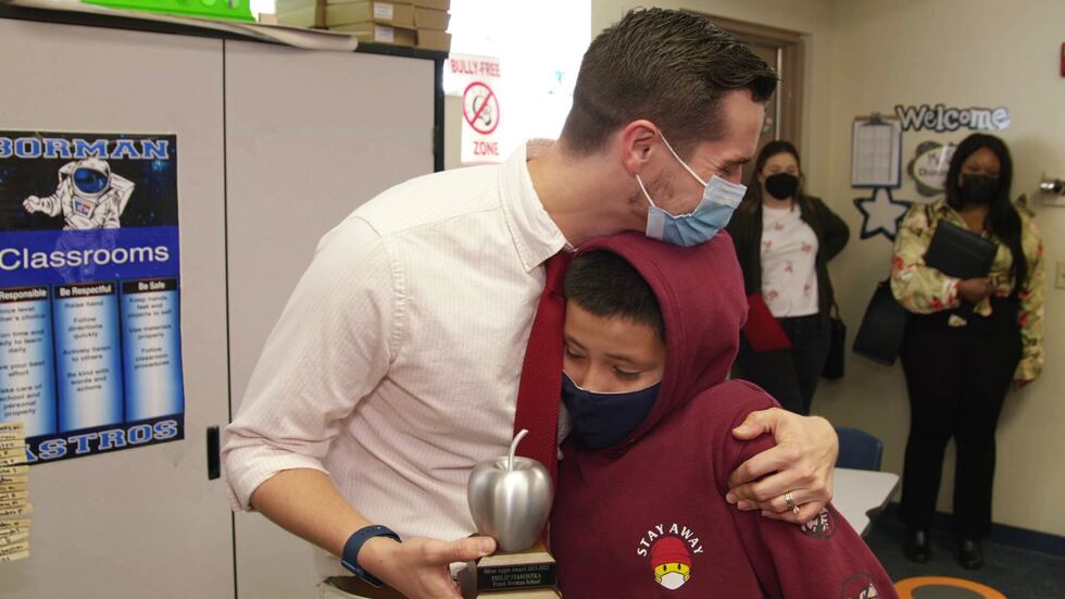 This images shows Philip Starostka hugging Jovanny Garcia, the student who nominated him for...
