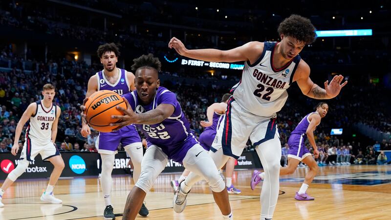 Grand Canyon guard Josh Baker, left, pulls in the ball as Gonzaga forward Anton Watson defends...