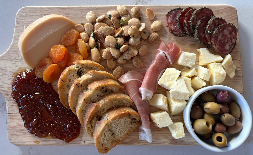The Bodega Board Charcuterie is served with artisan salami, prosciutto, artisan cheeses...