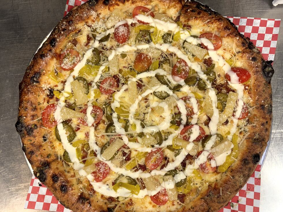 The Monsoon Pizza is an award pizza pie made with golden "sunshine" sauce, mozzarella,...