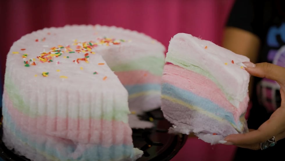 The cotton candy cake is made with several layers of flavored cotton candy and topped with...