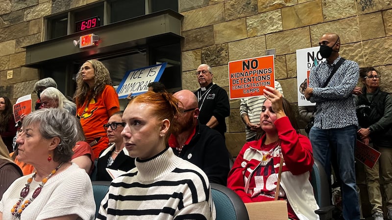 A town hall meeting, packed with both supporters and opponents of a data center, takes place...