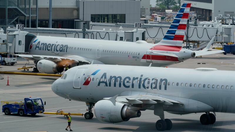 FILE - American Airlines passenger jets prepare for departure, Wednesday, July 21, 2021, near...