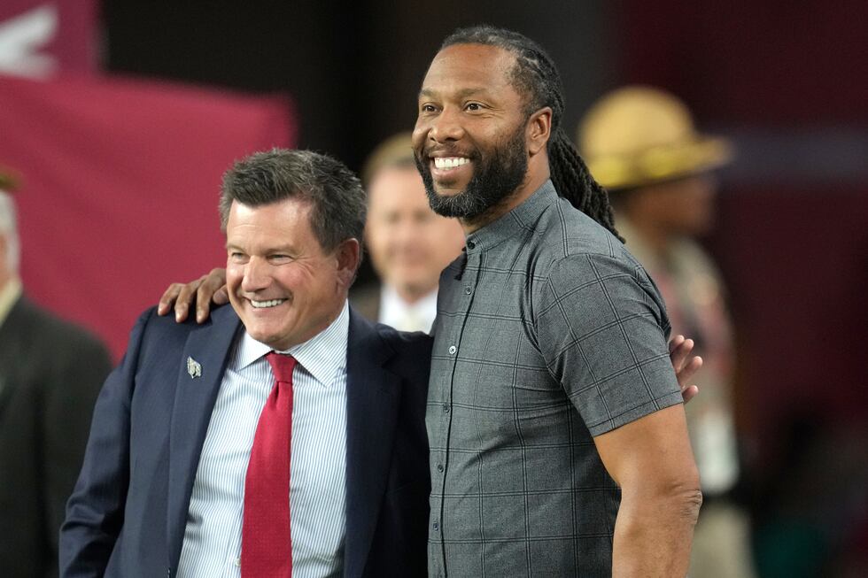 Arizona Cardinals owner Michael Bidwill, left, gets a hug from former Cardinals wide receiver...