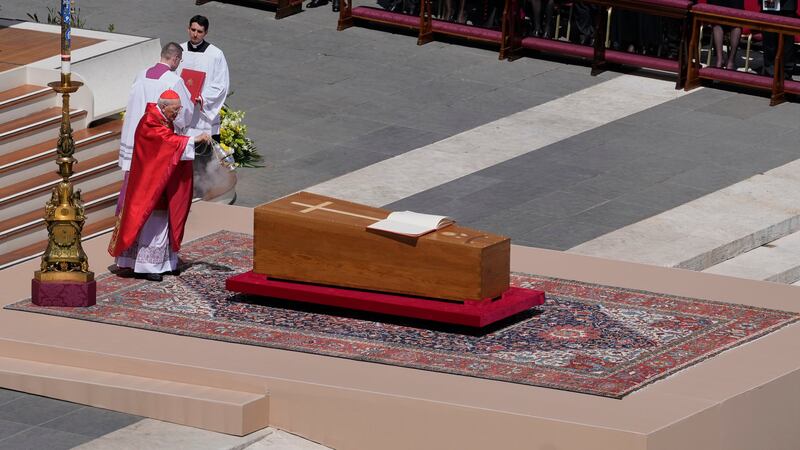Dean of the College of Cardinals Giovanni Battista Re spreads incense around the coffin of...