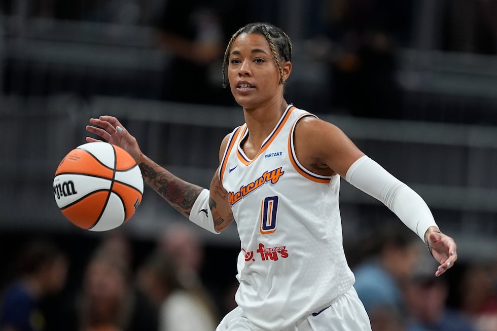 Phoenix Mercury's Natasha Cloud dribbles during the first half of a WNBA basketball game...