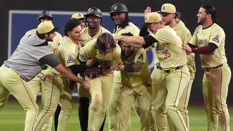 Arizona Diamondbacks' Jake McCarthy, center, celebrates his two-run walk off single against...