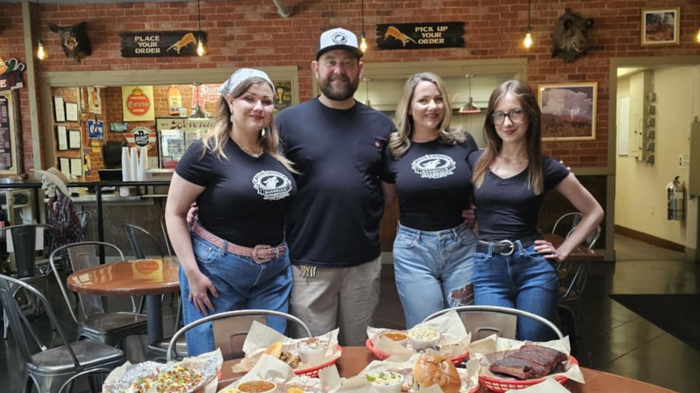 Cody and Beth Edgin (center) opened the Cryin' Coyote with their daughters, Tate (left) and...
