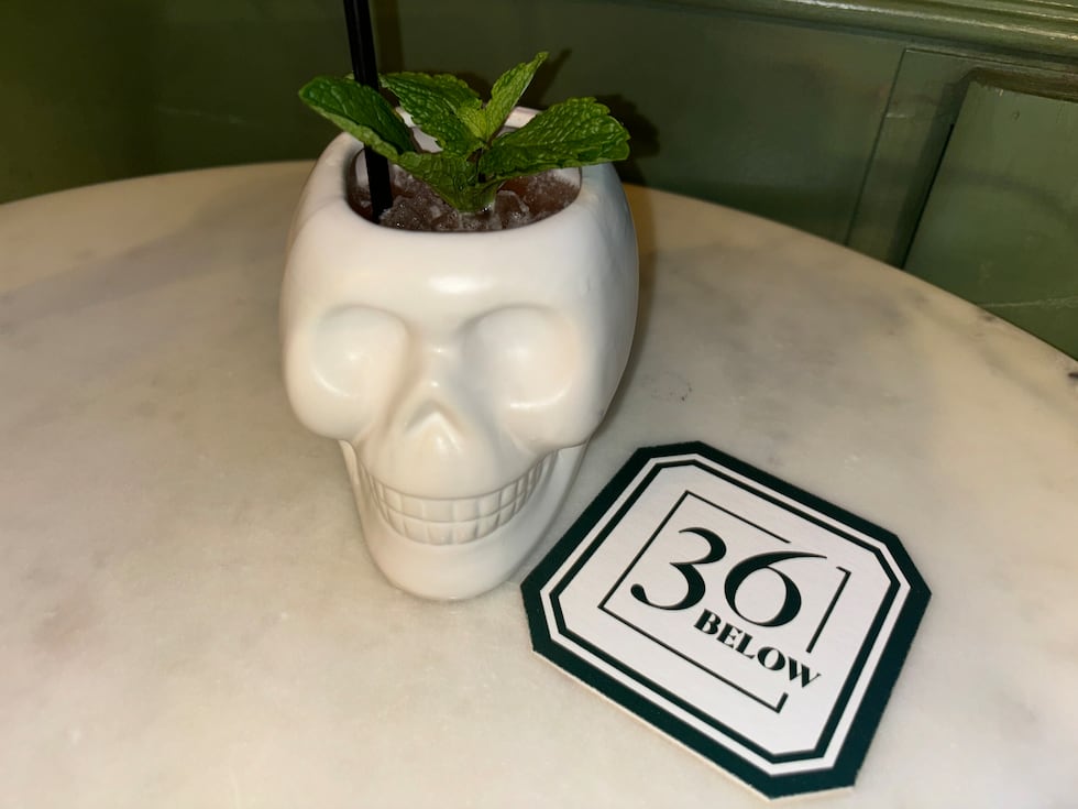 The Skull Crusher is a blood orange margarita served in a skull glass and garnished with fresh...