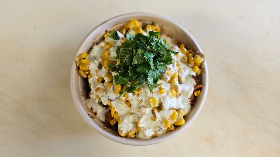 Topo serves tasty elote with crema, cheese, chile powder and cilantro.