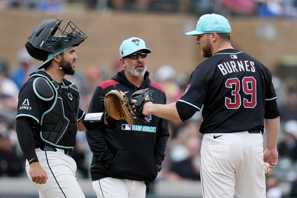 Arizona Diamondbacks starting pitcher Corbin Burnes (39) gets a visit from manager Torey...