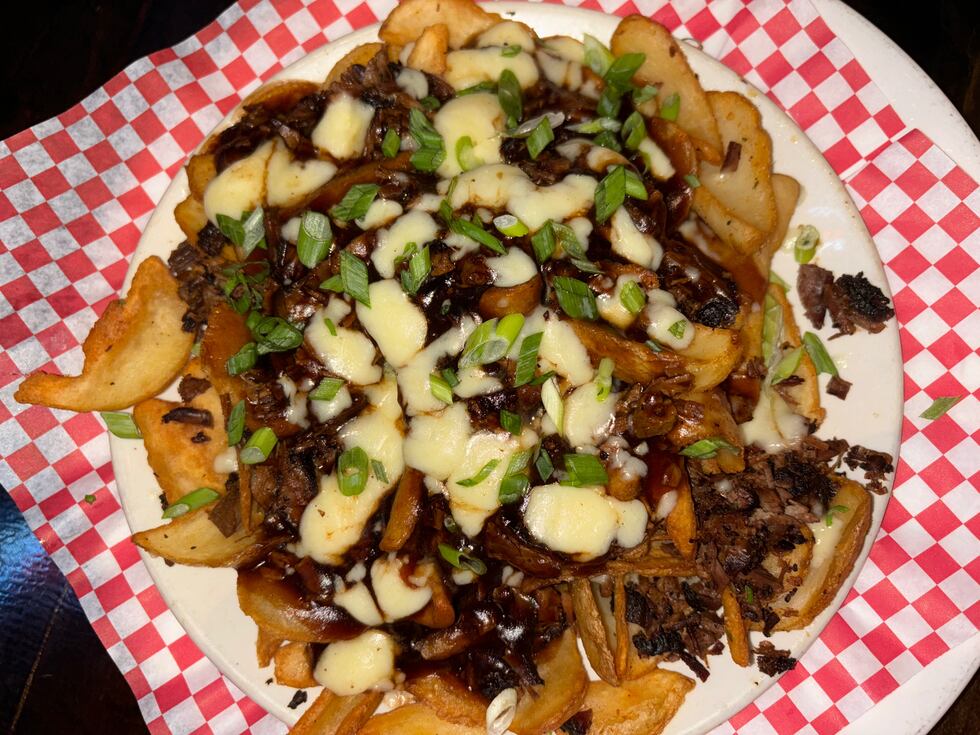 The Brisket Poutine is made with scooper fries and topped with house smoked beef brisket,...