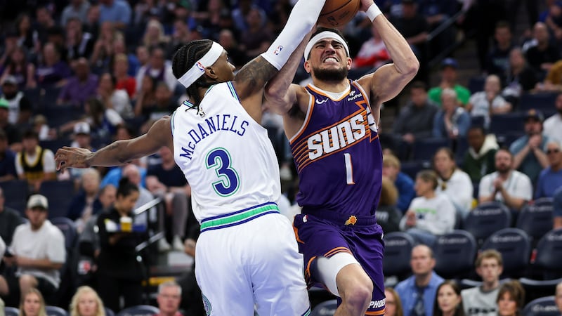 Phoenix Suns guard Devin Booker (1) shoots as Minnesota Timberwolves forward Jaden McDaniels...