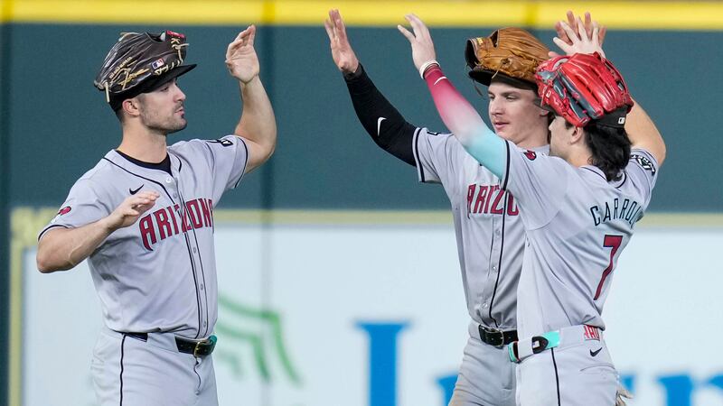 Arizona Diamondbacks' Randal Grichuk, left, Jake McCarthy, center, and Corbin Carroll...