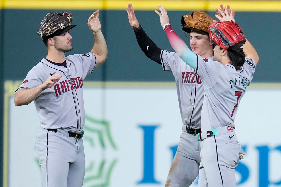 Arizona Diamondbacks' Randal Grichuk, left, Jake McCarthy, center, and Corbin Carroll...