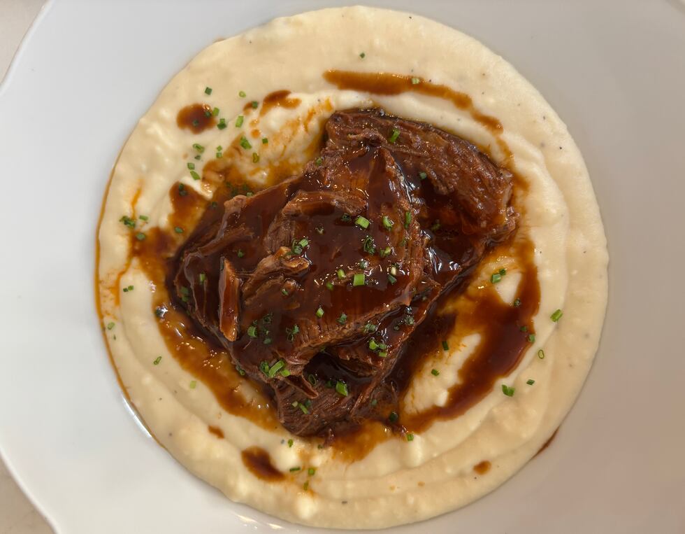 The 12-Hour Short Rib is braised overnight and served with mashed potato puree, demi glace,...