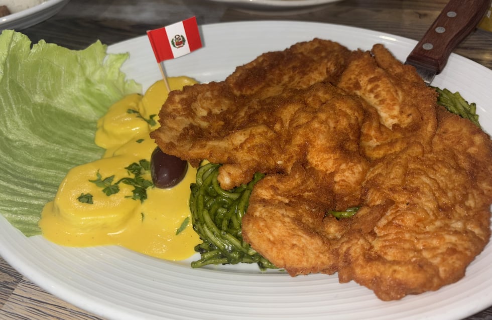 "Tallarin verde de pollo" is a fresh, pesto pasta served with fried chicken and a side of...