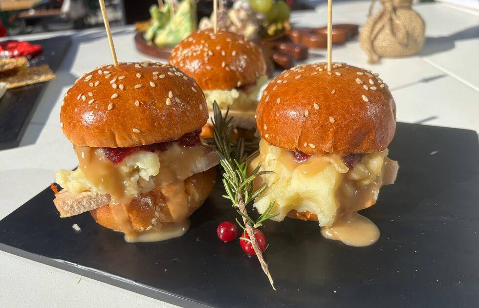 "Scrooge Sliders" some with oven roasted turkey, cranberry jam, mashed potatoes, and is served...