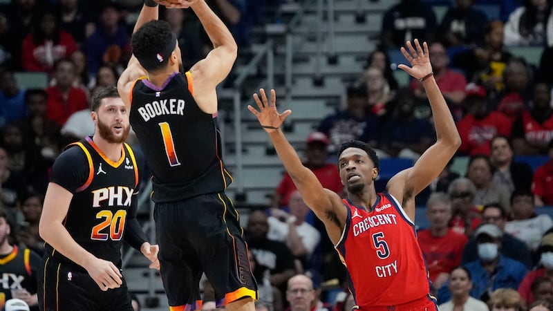 Phoenix Suns guard Devin Booker (1) shoots against New Orleans Pelicans forward Herbert Jones...