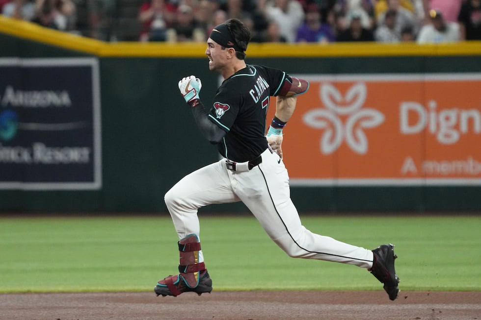 Arizona Diamondbacks' Corbin Carroll runs after hitting a triple against the Colorado Rockies...